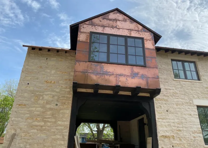 Copper metal panel facade on a stone building for Skylight Installation in Morrisville